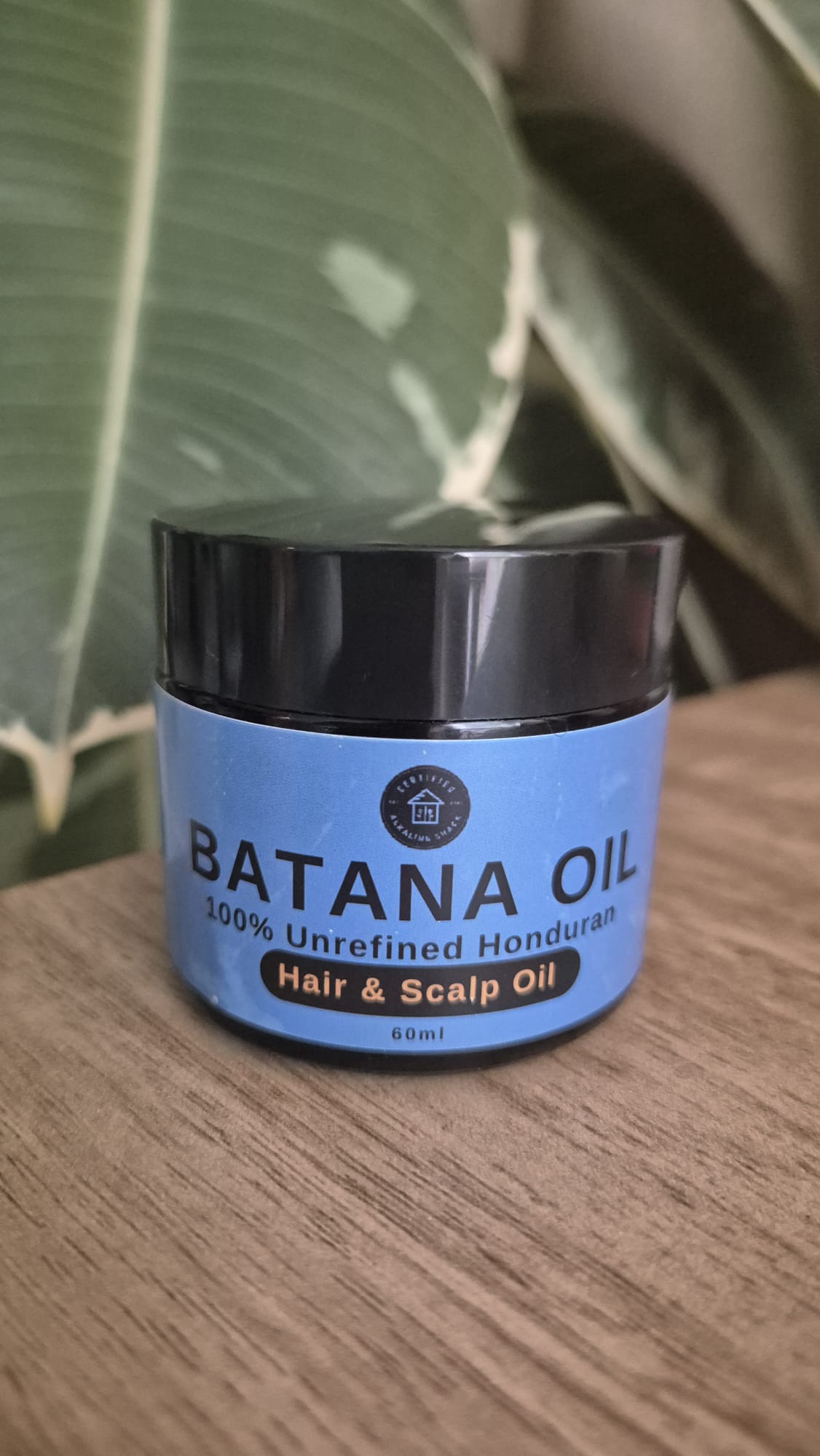 Batana oil container on table