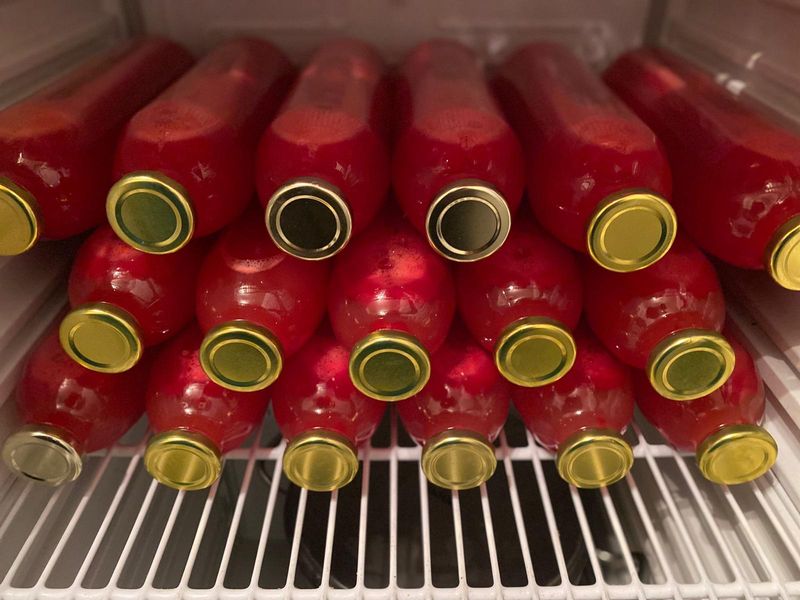 Bottles of red liquid stored